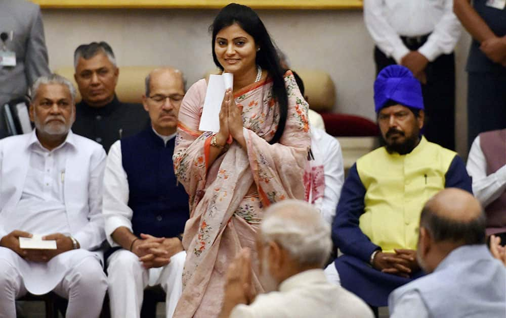 Apna Dal leader Anupriya Patel greets Prime Minister Narendra Modi as she walks to take the oath