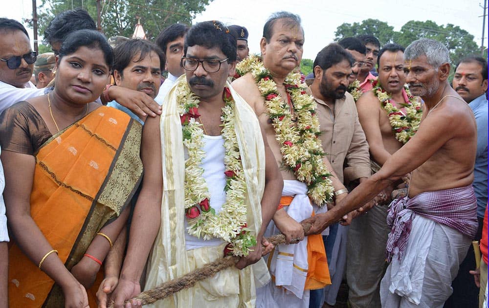 Former Union Minister and senior Congress leader Subodh Kant Sahay (3rd L) along with Jharkhand Mukti Morcha working President Hemant Soren (2nd L) performs rituals during annual Rath Yatra in Ranchi