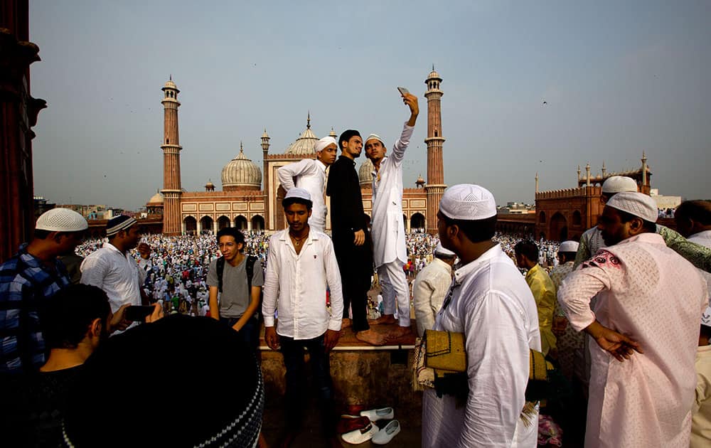 Muslims take selfies after offering Eid al-Fitr prayers at the Jama Mosque in New Delhi Muslims take selfies after offering Eid al-Fitr prayers at the Jama Mosque in New Delhi