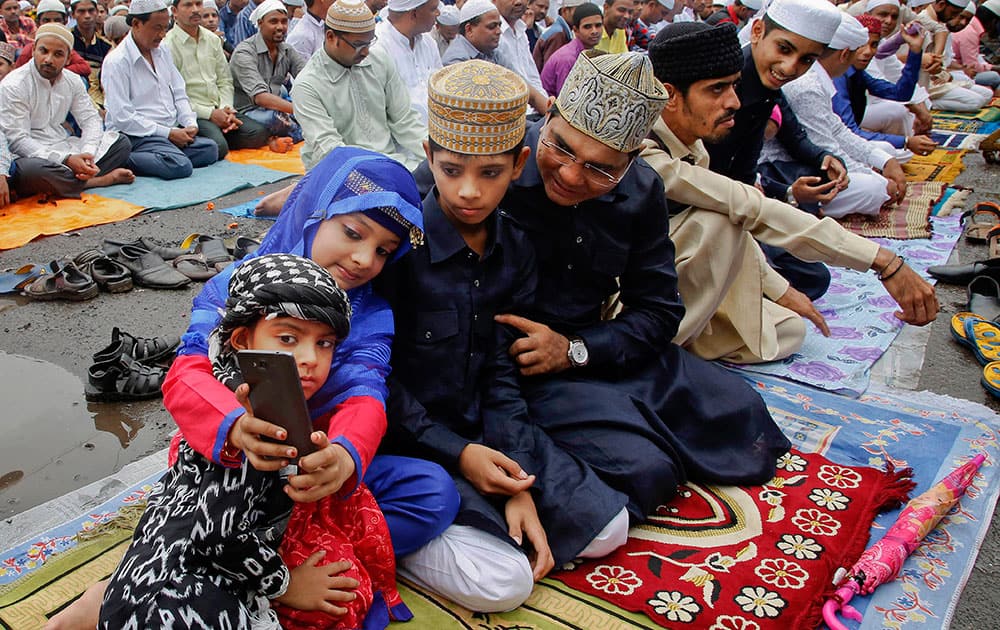 A Muslim family takes a selfie after offering Eid al-Fitr prayers in Mumbai A Muslim family takes a selfie after offering Eid al-Fitr prayers in Mumbai