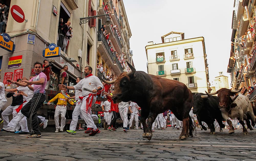 Revelers run in front of Jandilla's fighting bulls