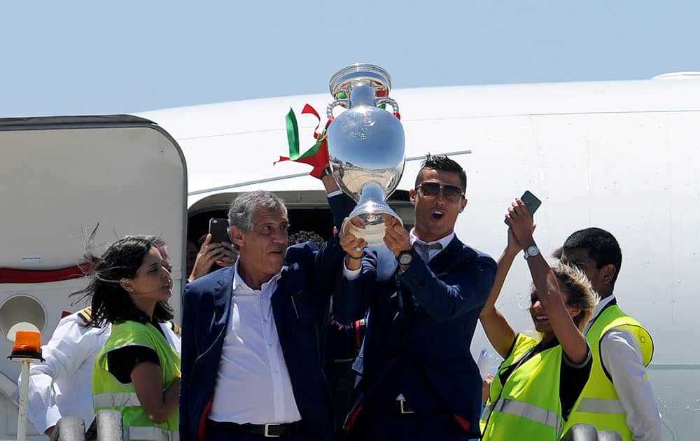 Portugal's Cristiano Ronaldo and coach Fernando Santos lift the Euro 2016 trophy