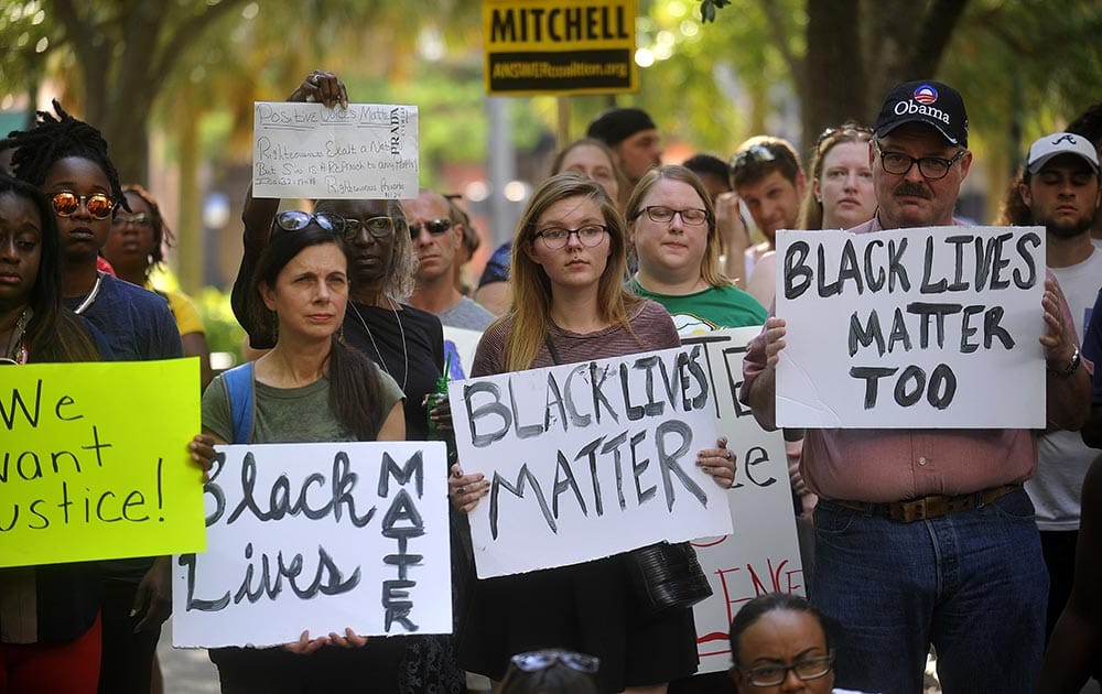 Protesters hold signs during a Black Lives Matter movement