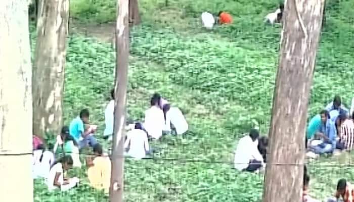 Dhanbad &#039;betters&#039; Bihar: Students sit under trees, write exams from books; father answers for his son