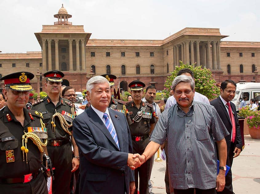 Defense Minister Manohar Parrikar, shakes hand with his Japanese counterpart Gen Nakatani 