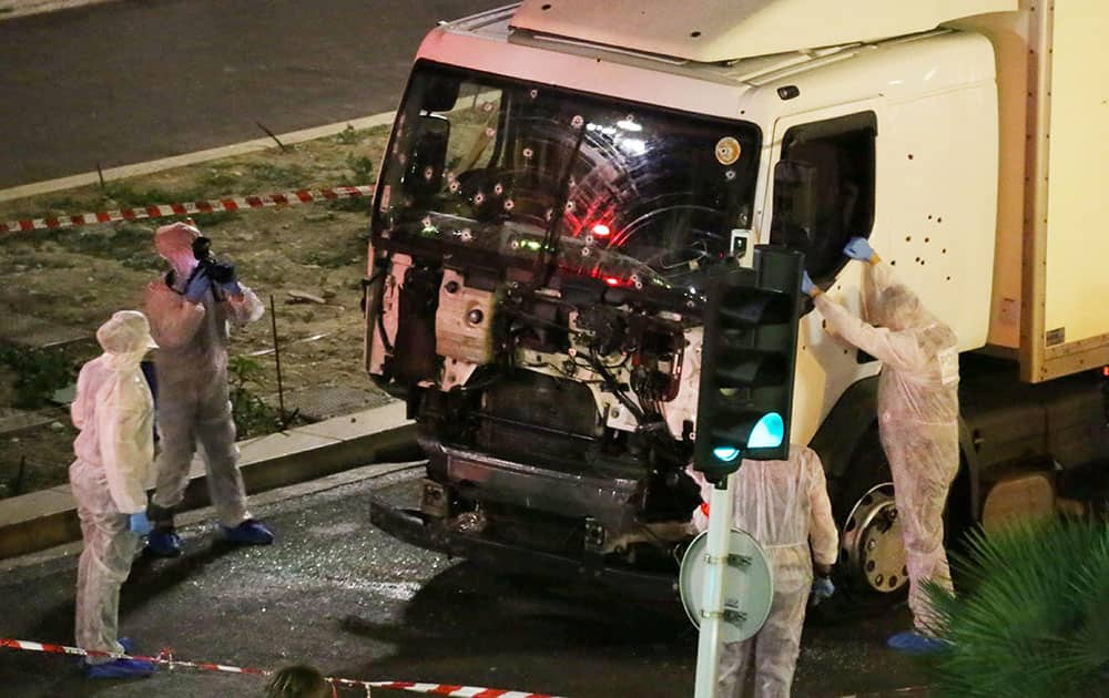 Authorities investigate a truck after it plowed through Bastille Day revelers in the French resort city of Nice, France