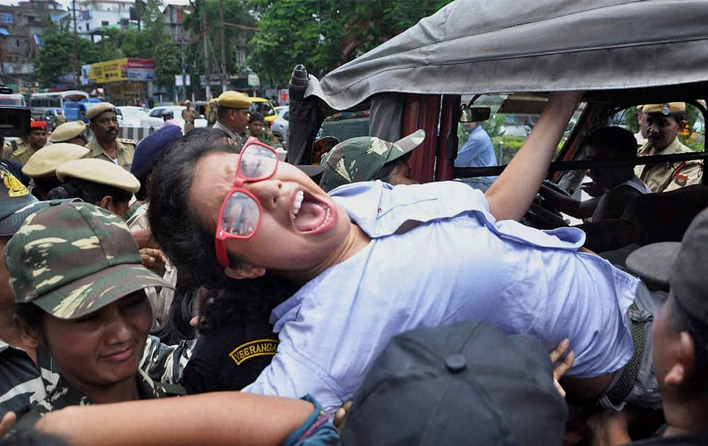 An activist of the Communist Party of India (Marxist) is forcefully carried away