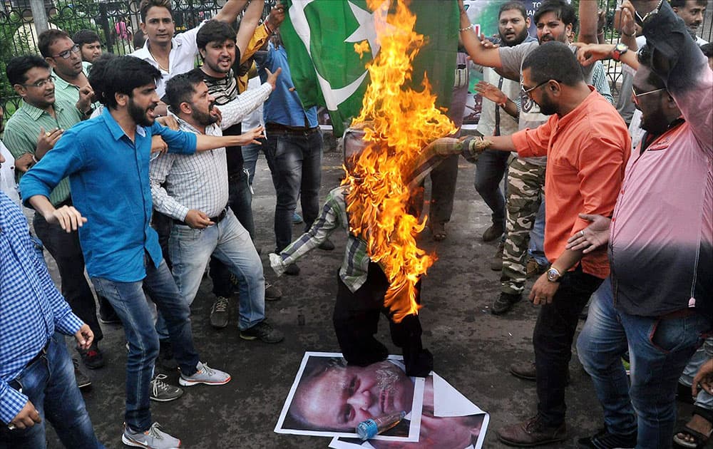 Members of Youth Gujarat burn effigy of Pakistan PM Nawaz Sharif during a protest in Surat.