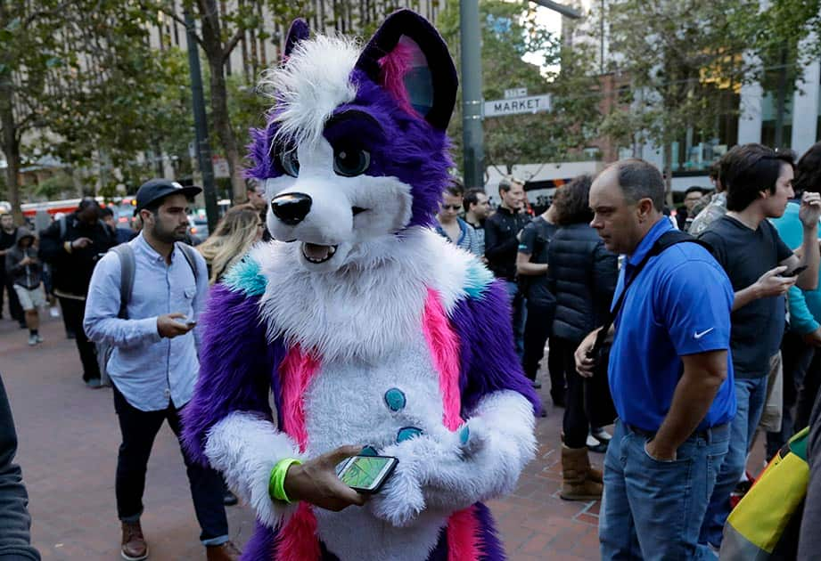 Ziggy Lotivio wears a costume as he participates in a group walk with fellow 'Pokemon Go' players , in San Francisco.