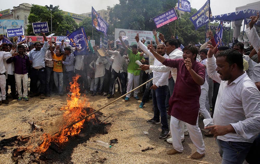 Bahujan Samaj Party supporters burn an effigy of Bharatiya Janata Party