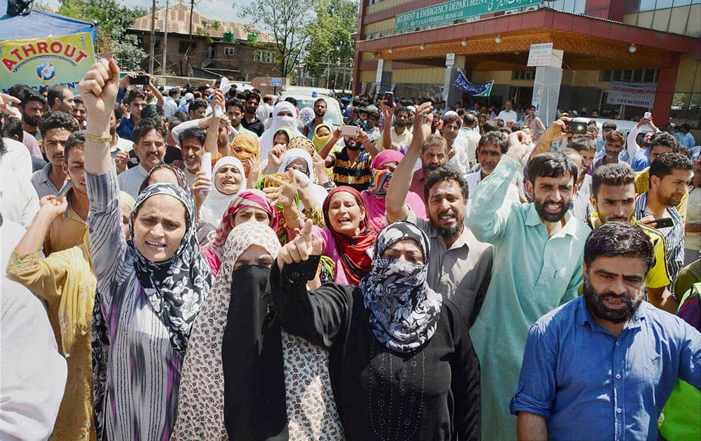 Local people along with attendants of patients shout slogans, Srinagar.