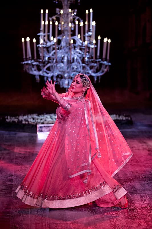 A dancer displays a design by Indian designer Tarun Tahiliani at the India Couture Week