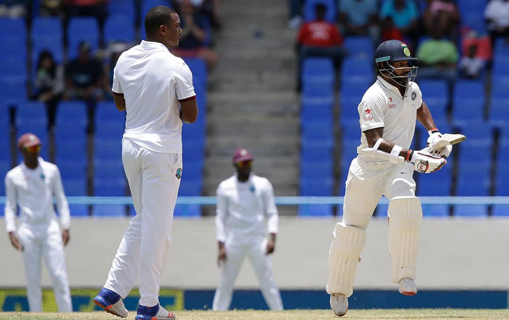 Shikhar Dhawan scores runs after playing a shot bowled by West Indies' Shannon Gabriel