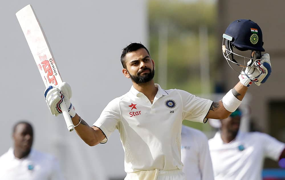 Virat Kohli celebrates after he scored a century