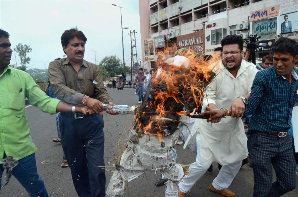 Congress party workers burn an effigy of Prime Minister