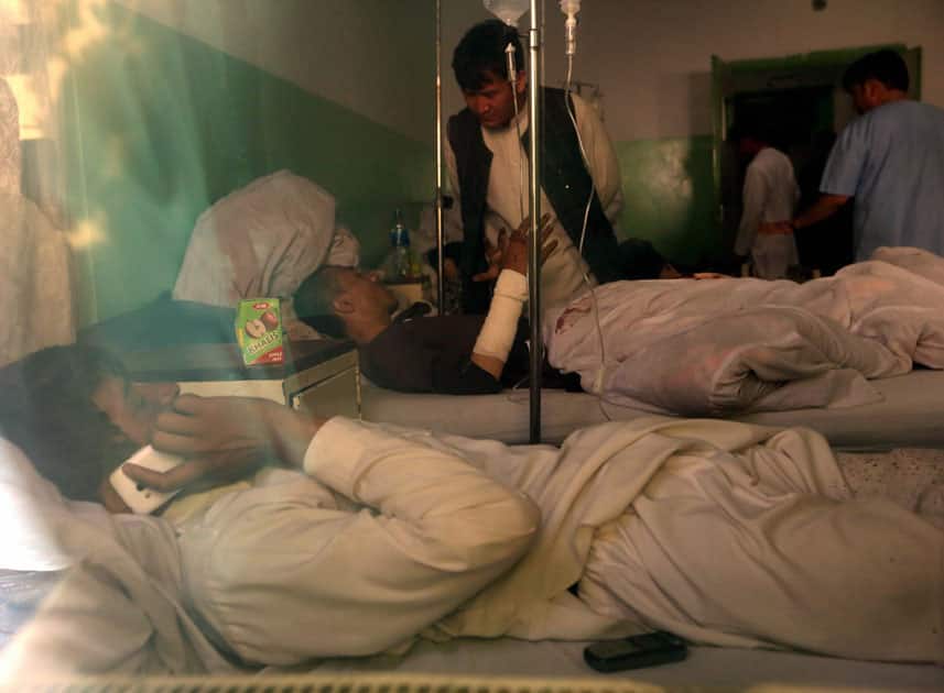 Injured Afghans lie in a hospital