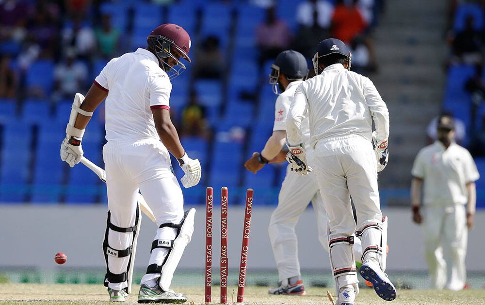 West Indies' Shannon Gabriel looks at the wicket after being bowled out by India'sRavichandran Ashwin