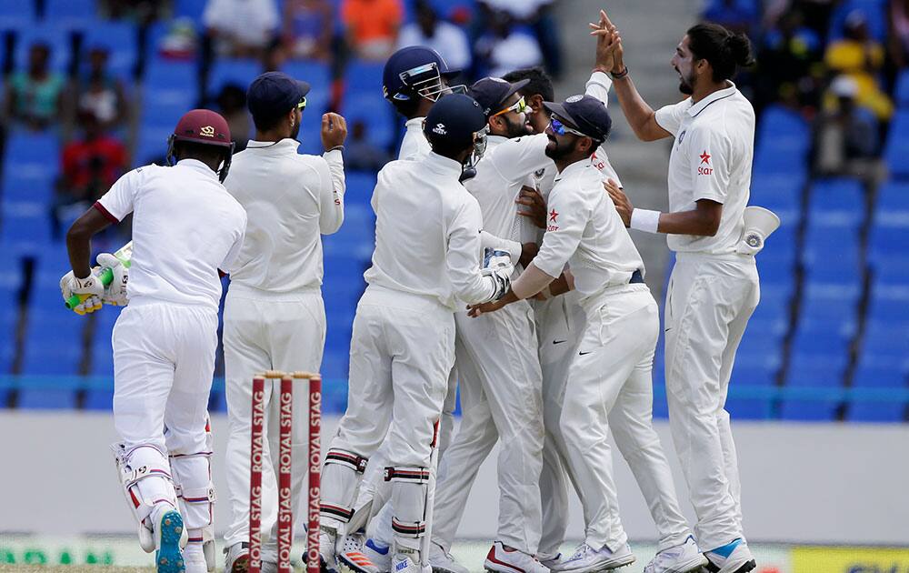 Indian players surround captain Virat Kohli after he caught West Indies' Jermaine Blackwood