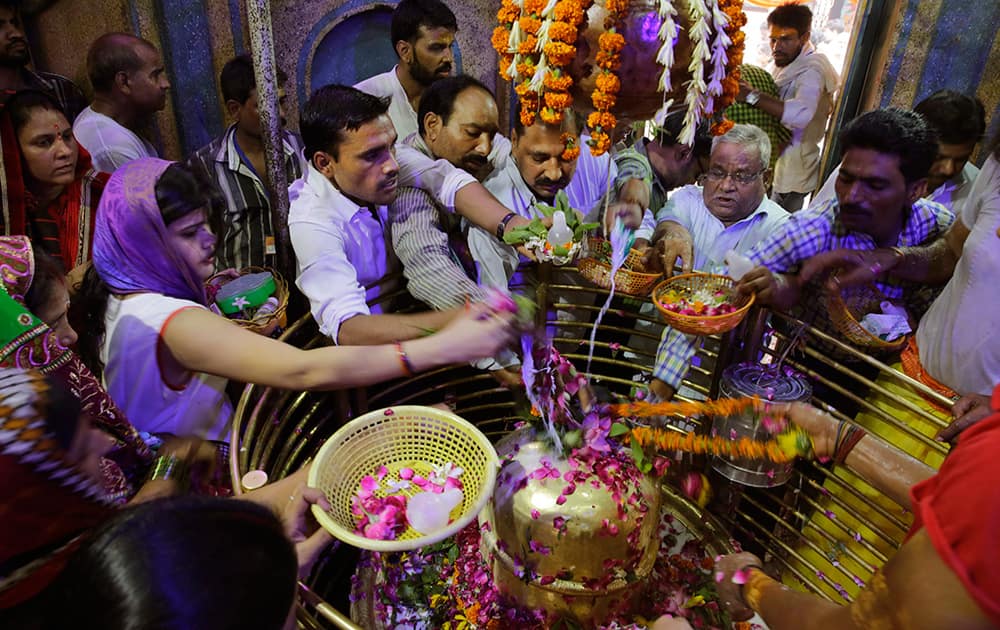 Devotees offer prayer to god Shiva