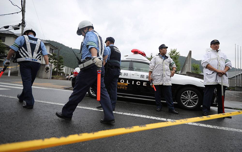 Police officers stand guard at the main gate of Tsukui Yamayuri-en Police officers stand guard at the main gate of Tsukui Yamayuri-en