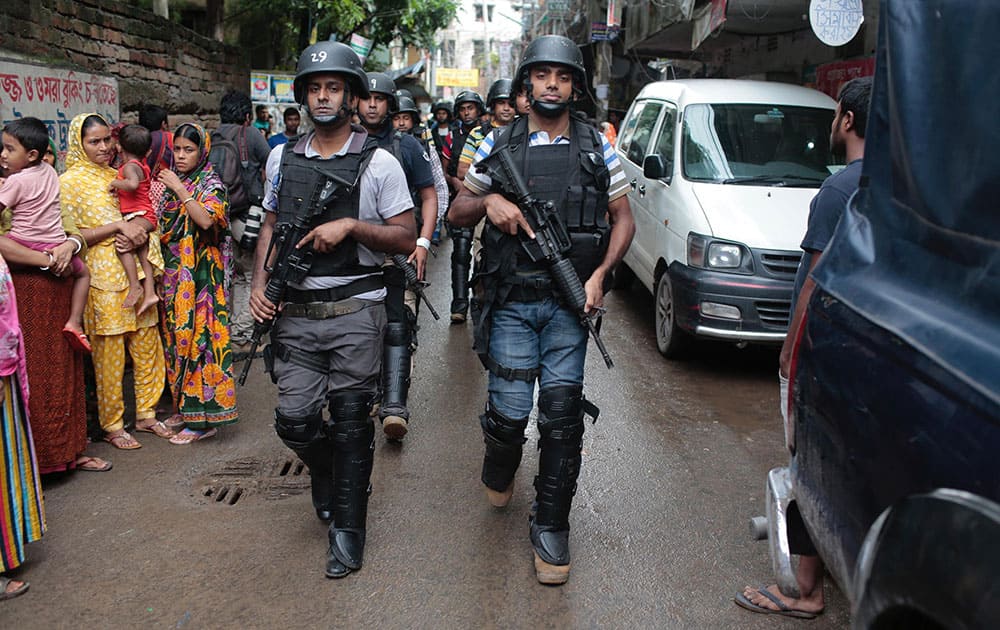 Policemen return from a raid on a building in Dhaka Policemen return from a raid on a building in Dhaka