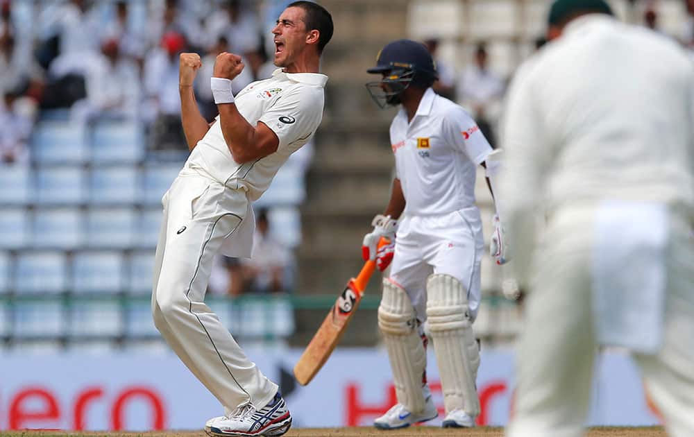 Mitchell Starc celebrates after taking the wicket of Sri Lanka's Dimuth Karunaratne Mitchell Starc celebrates after taking the wicket of Sri Lanka's Dimuth Karunaratne