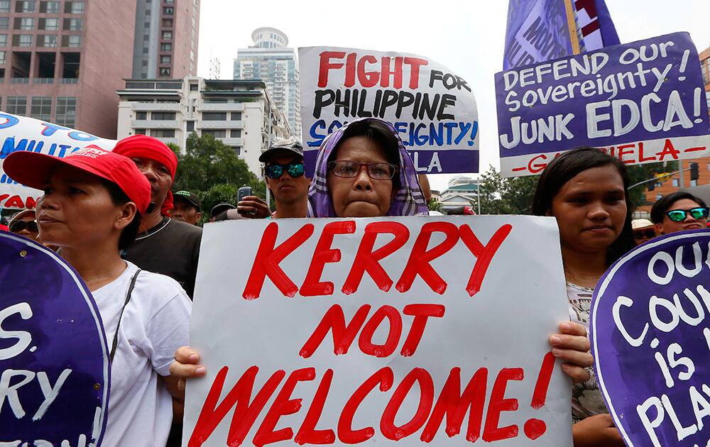 Protesters display placards during a rally Protesters display placards during a rally