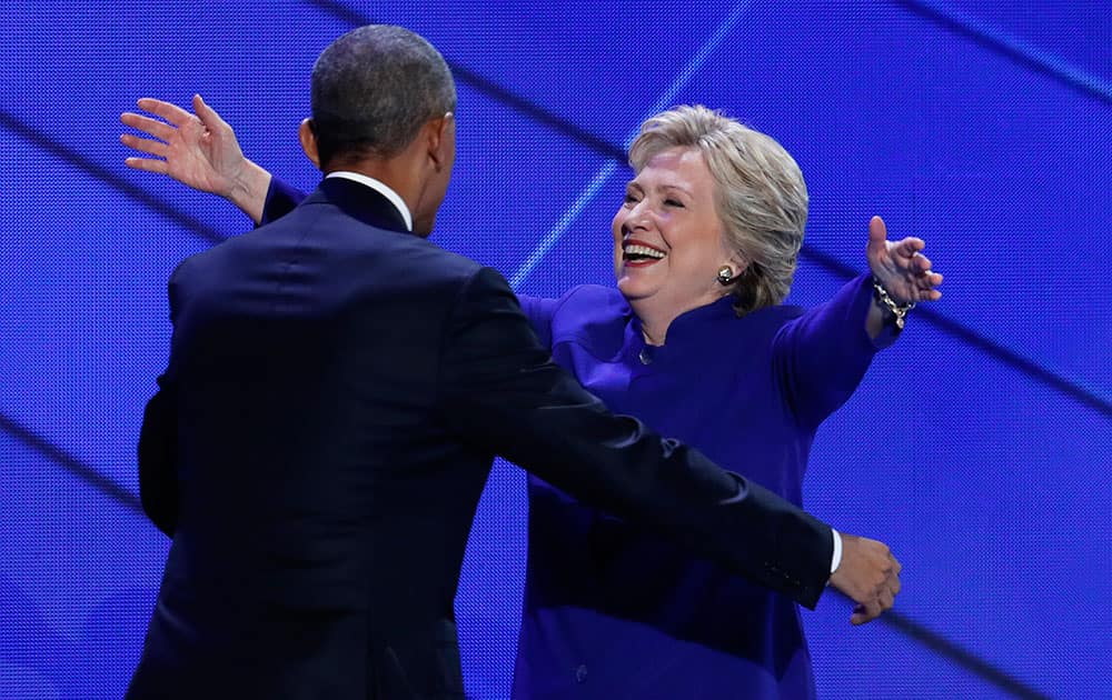 Democratic presidential nominee Hillary Clinton hugs President Barack Obama during the third day of the Democratic National Convention