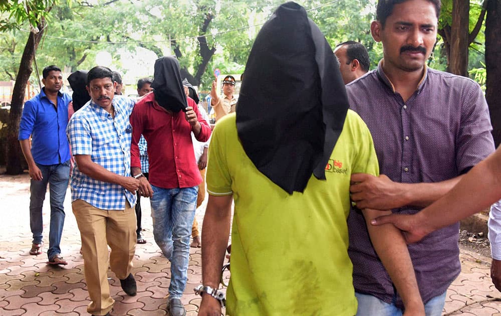 Police take away accused persons after their arrest in Santacruz murder case in Mumbai