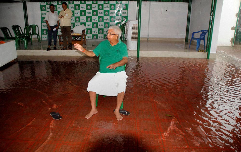 RJD Chief Lalu Prasad looking at his waterlogged residence after a press conference in Patna