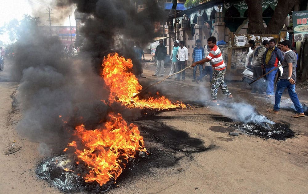 Locals try to douse a car godown that caught fire at Panagarh in Burdwan Locals try to douse a car godown that caught fire at Panagarh in Burdwan