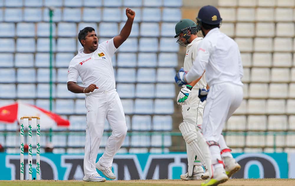 Rangana Herath celebrates the wicket of Australia's David Warner Rangana Herath celebrates the wicket of Australia's David Warner