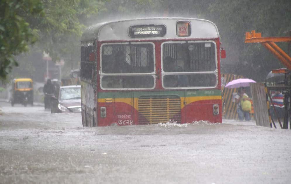 Vehicles plying at a flooded road