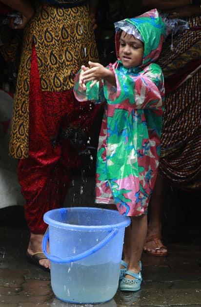 A child plays in the rain in Mumbai.