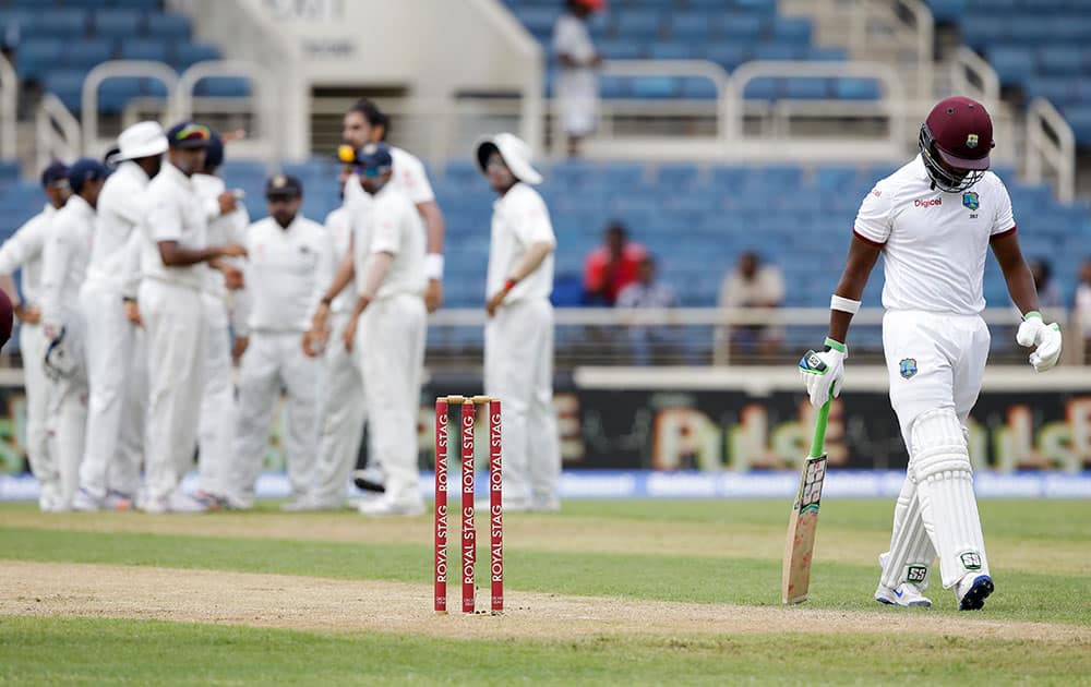 Darren Bravo walks to the pavilion after being caught