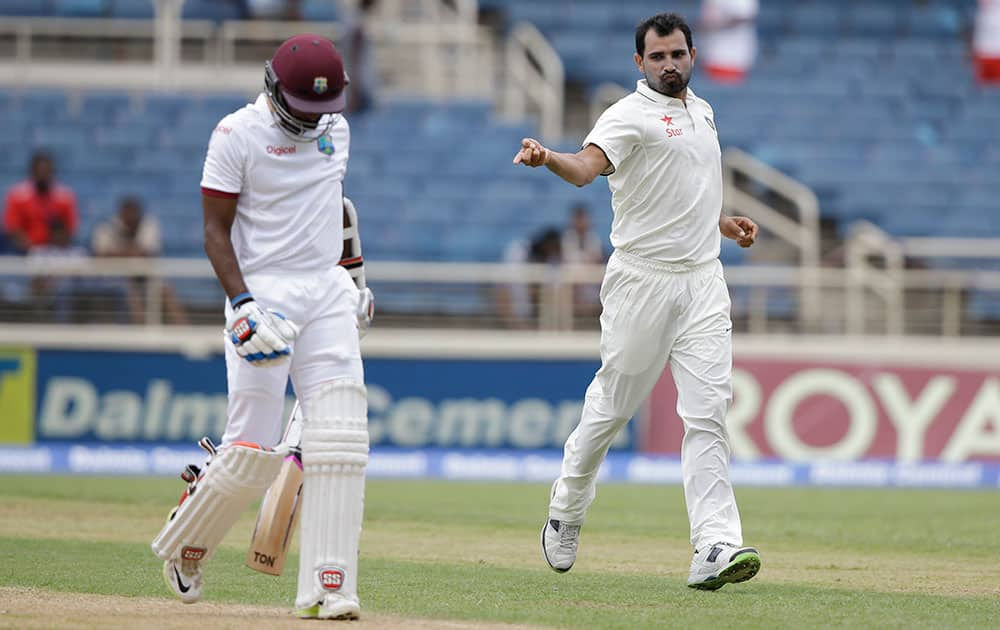 Mohammed Shami celebrates taking the wicket of West Indies' Rajendra Chandrika