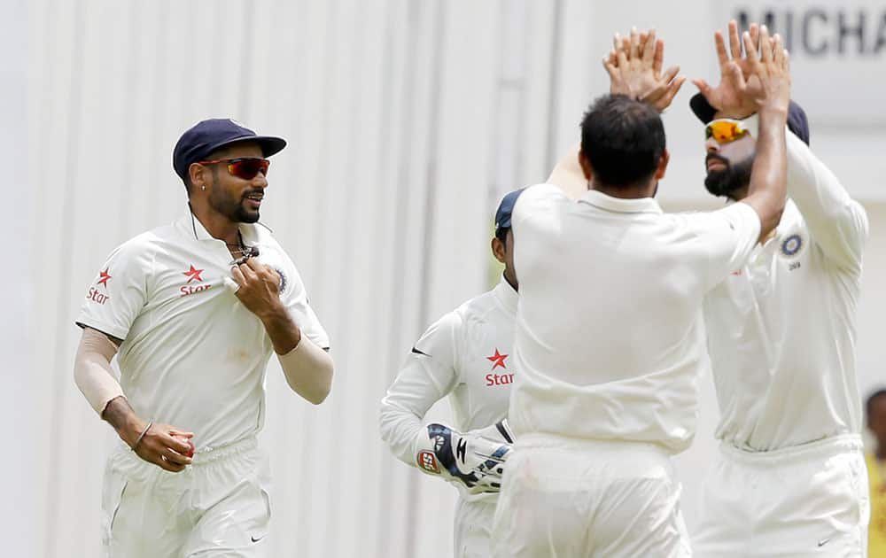 Shikhar Dhawan celebrates after he caught West Indies' Shane Dorwich