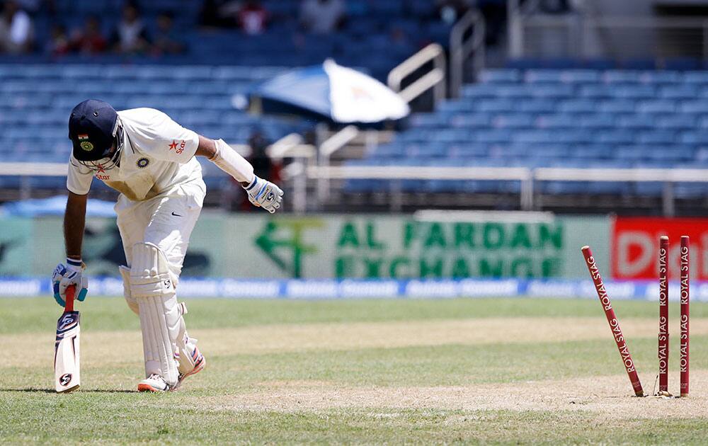 Cheteshwar Pujara stands up to leave the pitch after being run out