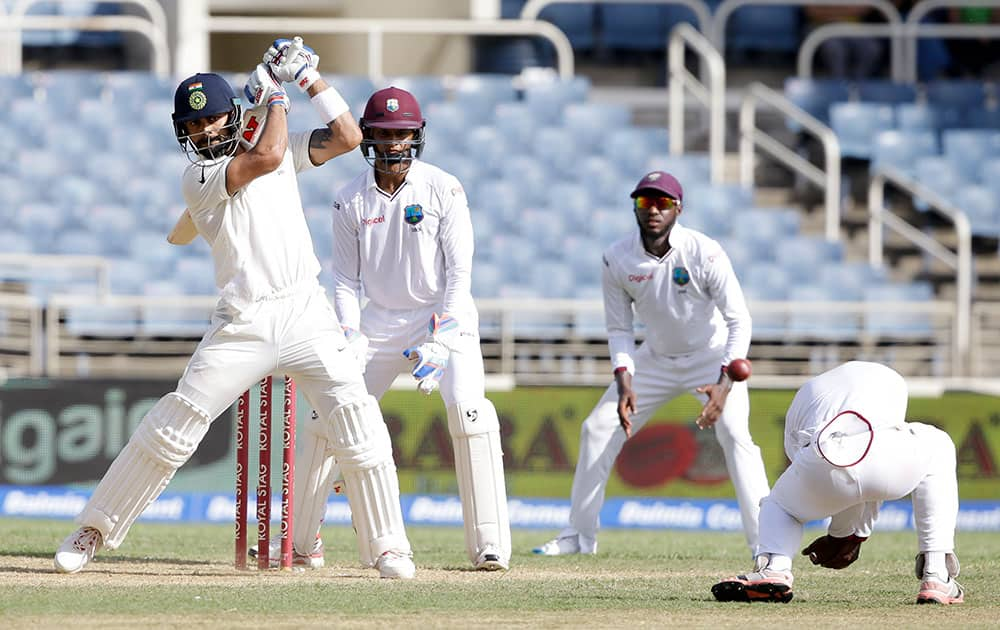 Virat Kohli hits a four off West Indies' Devendra Bishoo