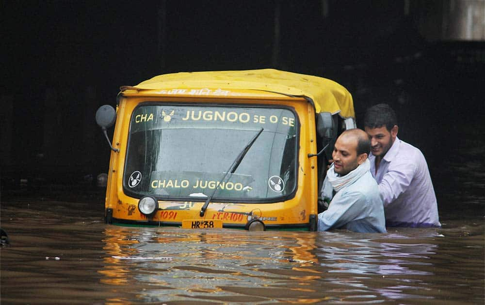 Two men pushing an autorickshaw