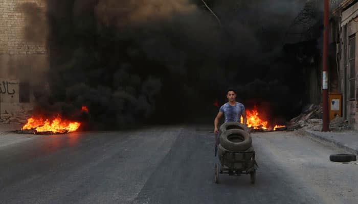 Syrian children burn tyres to obstruct warplanes bombarding besieged Aleppo