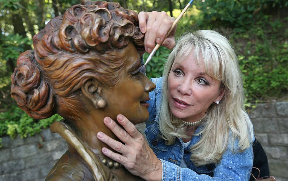 Artist Carolyn Palmer prepares to apply a cold patina to her bronze statue of Lucille Ball in Saddle River, N.J.