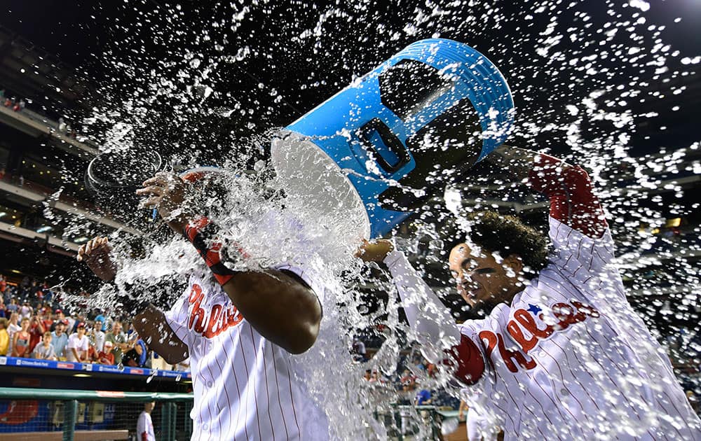 Philadelphia Phillies' Maikel Franco is doused with water by Freddy Galvis, after driving in the winning run off San Francisco Giants' Jake Peavy