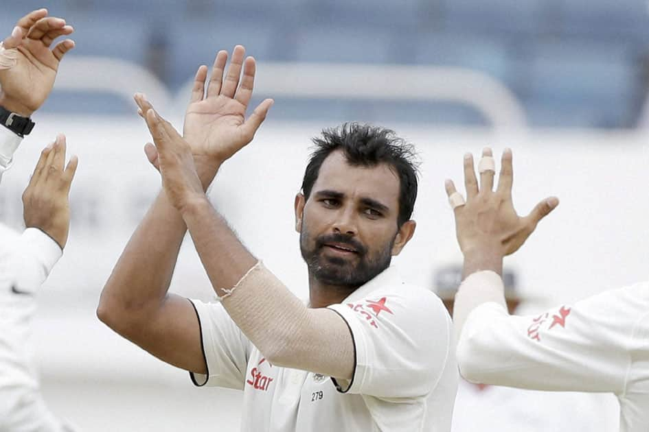 Indias bowler Mohammed Shami is congratulated by teammates