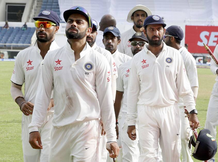 Players leave the field after agreeing to call out the match for a draw