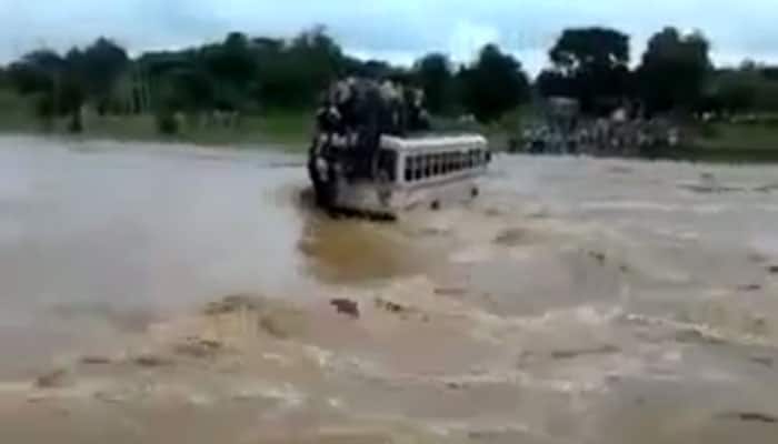 Shocking! Bus overloaded with passengers swept away by flash flood – WATCH