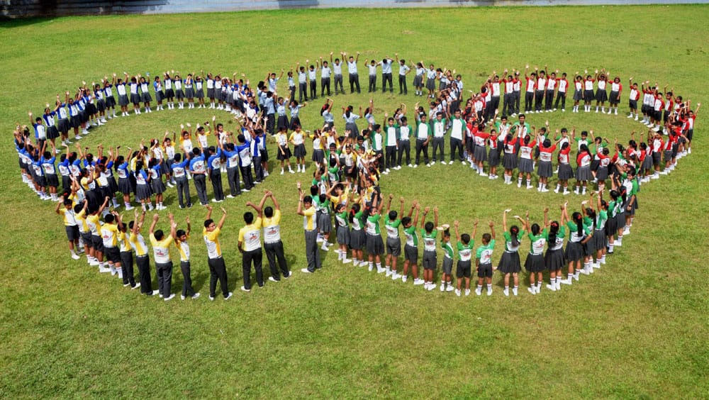 School children form Olympics rings