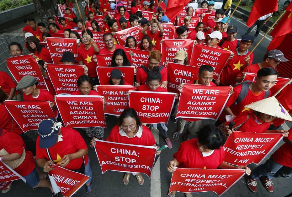 Filipinos and Vietnamese residents display placards