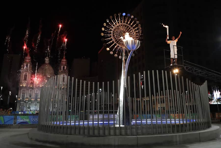 Jorge Alberto Oliveira Gomes reacts after lighting the Olympic cauldron