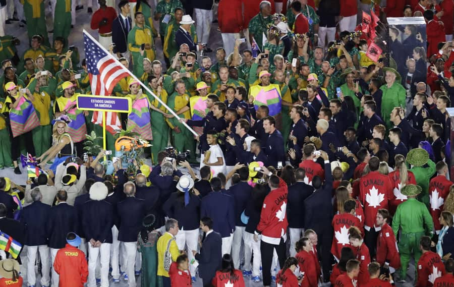 Michael Phelps carries the flag of the United States